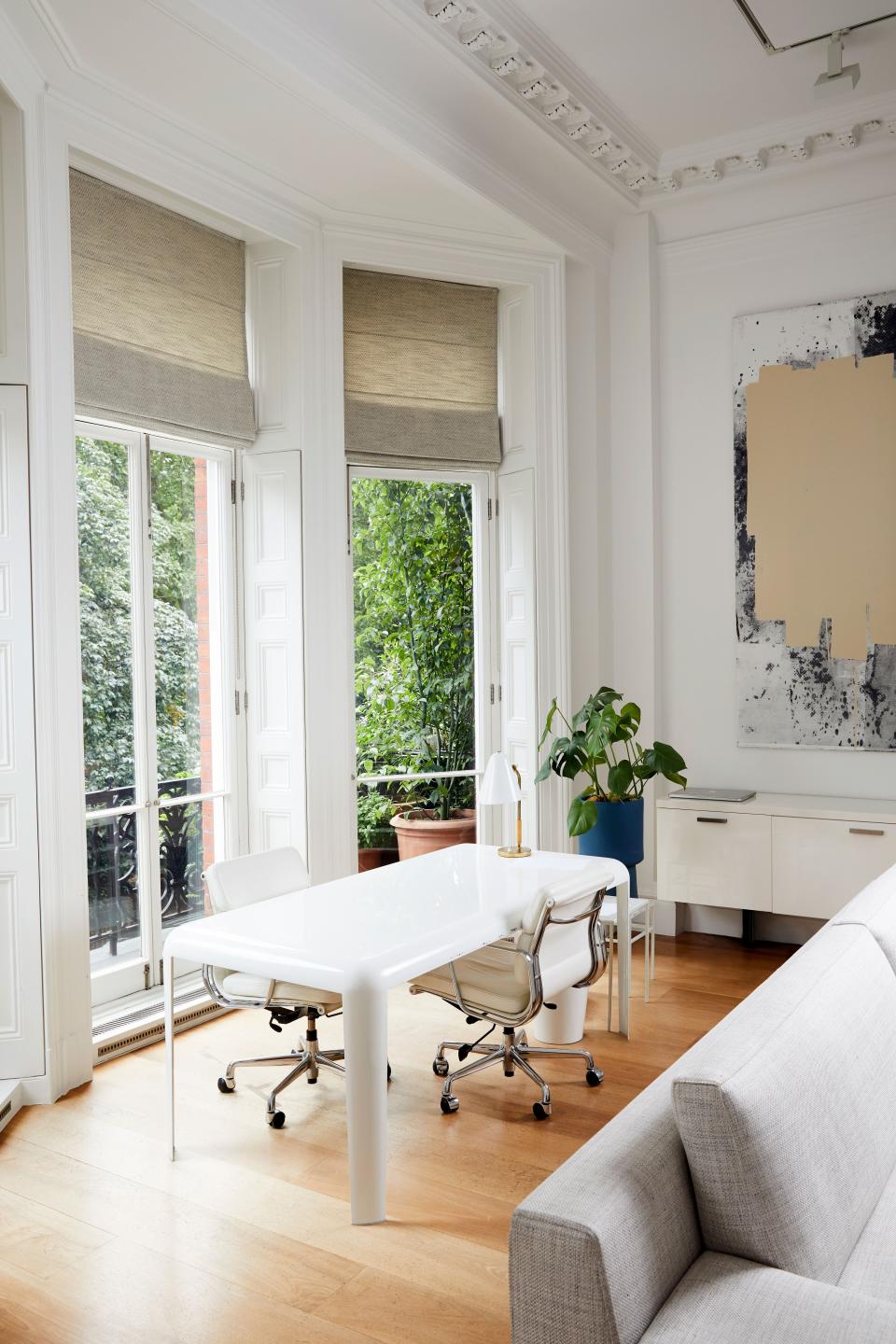 This corner of the family room, which overlooks a private garden, is furnished with a white metal “Ferro” desk by Piero Lissoni and white “Soft Pad” leather chairs by Charles & Ray Eames. “I worked out of here when I founded my company,” says de la Cruz, referring to the jewelry line she launched a decade ago with former fashion director Tierney Horne. On the back wall, we see an abstract painting by American artist Christopher Wool.