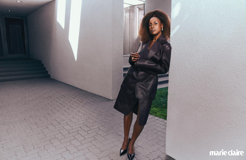 Issa Rae in Bottega Veneta blazer and skirt; Shay earrings; Anne Sisteron ring; Jimmy Choo shoes. 