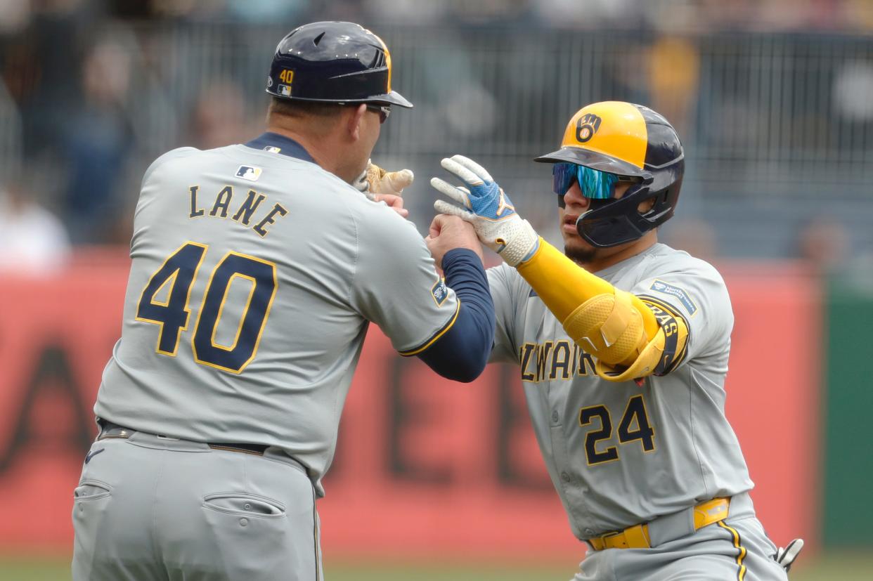 Brewers third base coach Jason Lane congratulates catcher William Contreras on his solo home run against the Pirates in the first inning Thursday in Pittsburgh.