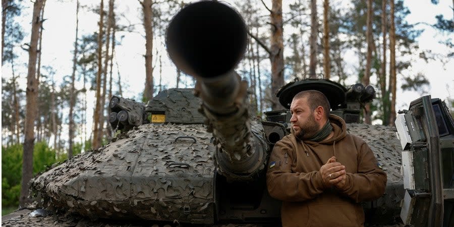 Soldier of the 21st Separate Mechanized Brigade of the Armed Forces of Ukraine near a Swedish-made CV90 infantry fighting vehicle in Donetsk Oblast, May 12, 2024.