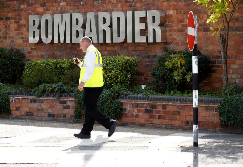 FILE PHOTO: A worker walks past the entrance to the Bombardier plant in Derby