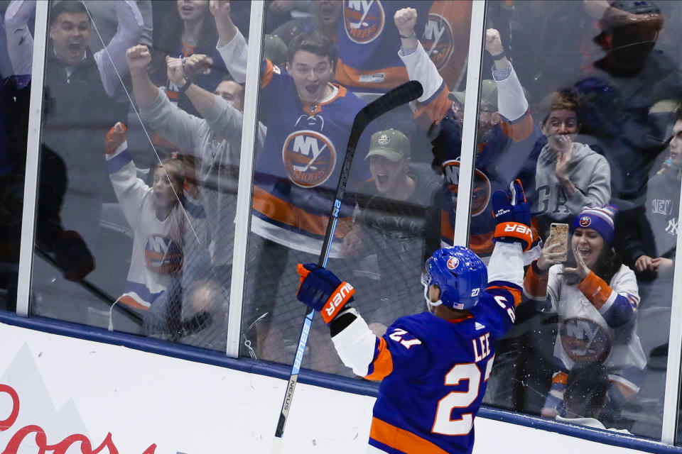 Fans cheer for New York Islanders' Anders Lee (27) after Lee scored a goal during the third period of the team's NHL hockey game against the Tampa Bay Lightning on Friday, Nov. 1, 2019, in Uniondale, N.Y. The Islanders won 5-2. (AP Photo/Frank Franklin II)