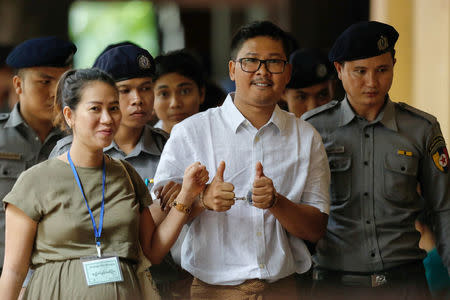 Detained Reuters journalist Wa Lone walks with his wife Pen ei mon as he arrives at Insein court in Yangon, Myanmar July 23, 2018. REUTERS/Ann Wang