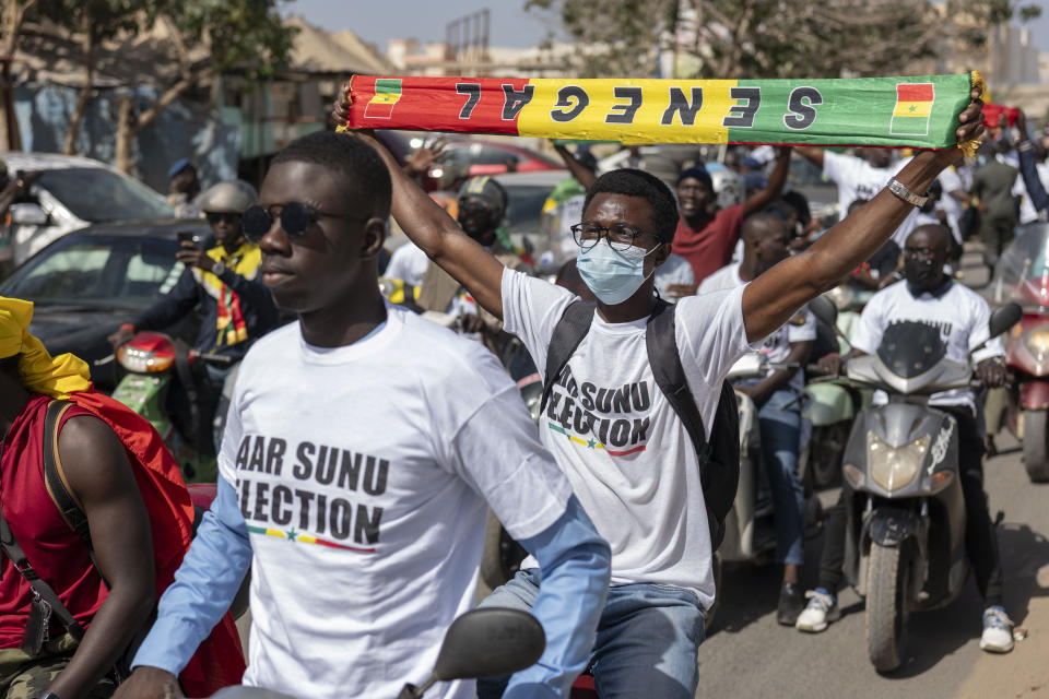 Supporters of the Aar Sunu Senegal opposition collective demonstrate on a street, in Dakar, Saturday, Feb. 17, 2024. Senegal's government says it will hold a presidential election as soon as possible given that the country's top election authority has overturned a decree by President Macky Sall to postpone the vote. (AP Photo/Sylvain Cherkaoui)