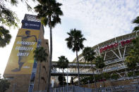 An image of baseball great Jackie Robinson hangs near Petco Park, where a baseball game between the San Diego Padres and the Seattle Mariners had been scheduled Wednesday, Aug. 26, 2020, in San Diego. Two Major League Baseball games have been postponed as players across the sports landscape reacted in the wake of the weekend shooting by police of Jacob Blake, a Black man, in Wisconsin. A pair of Major League Baseball games were postponed Wednesday as players across the sports landscape reacted in the wake of the weekend shooting by police of Jacob Blake, a Black man, in Wisconsin. Games between the Cincinnati Reds and Brewers in Milwaukee and the Mariners and Padres in San Diego were called off hours before they were set to begin. (AP Photo/Gregory Bull)