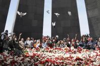 Armenians release white doves and lay flowers at a 2008 memorial to victims of the genocide in Yerevan