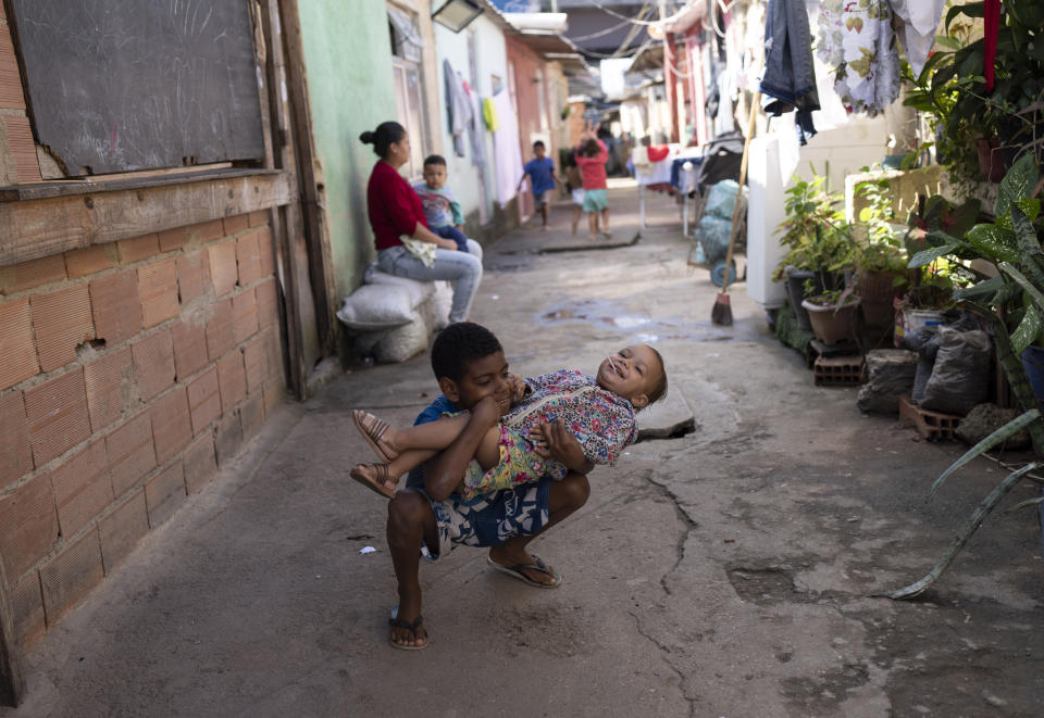 Children play near their homes built on squatted land that has been occupied by hundreds of poor families since 2018 in Rio de Janeiro, Brazil, Monday, June 20, 2022. Rising inflation is eroding the buying power of consumers and angering potential voters, who fault President Jair Bolsonaro. (AP Photo/Silvia Izquierdo)