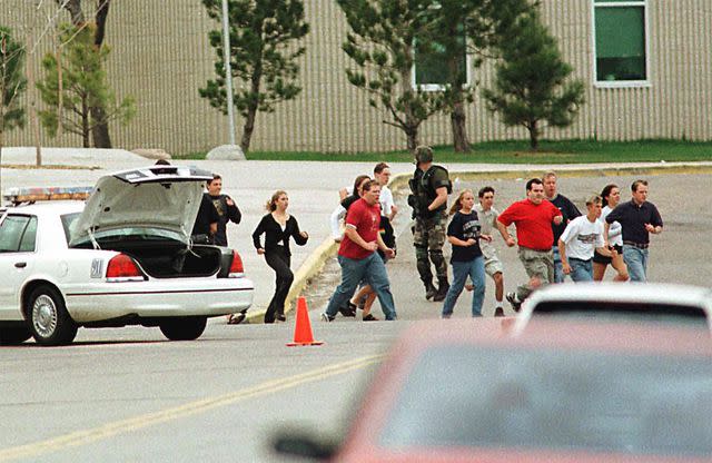 MARK LEFFINGWELL/AFP/Getty Students fleeing Columbine on April 20, 1999