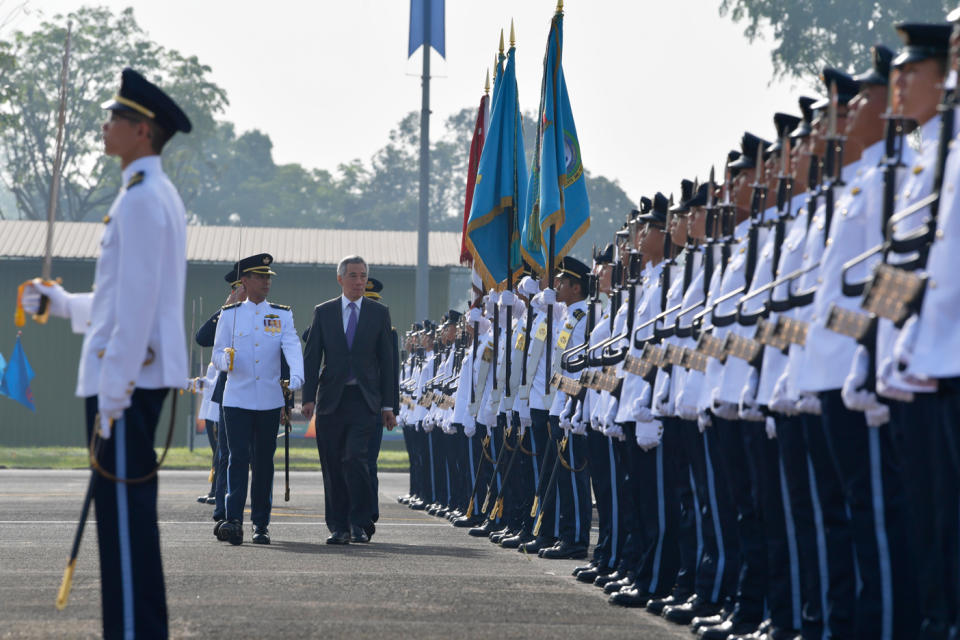 <p>Prime Minister Lee Hsien Loong reviewing the Guard of Honour at the RSAF50 Parade at Tengah Air Base on Saturday (1 September). (PHOTO: Mindef) </p>