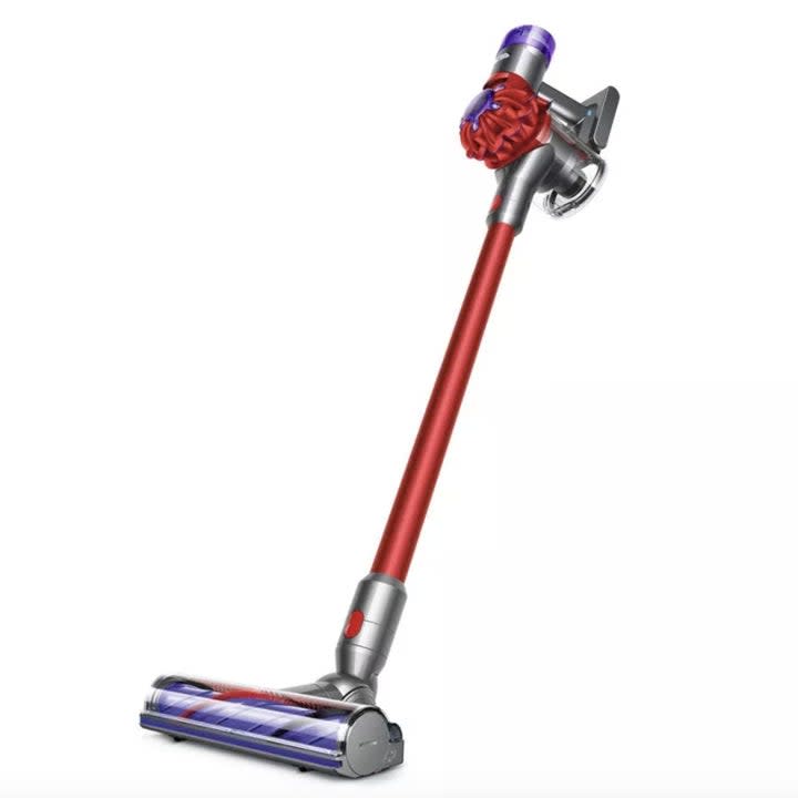 A red and purple Dyson stick vacuum