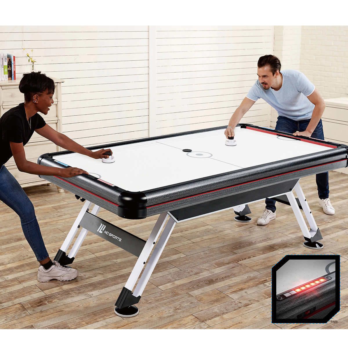 Two people playing air hockey on Medal Sports table from Costco