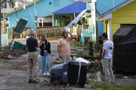 Residents survey the damages along the waterfront following the effects of Hurricane Isaias in Southport, N.C., Tuesday, Aug. 4, 2020. (AP Photo/Gerry Broome)