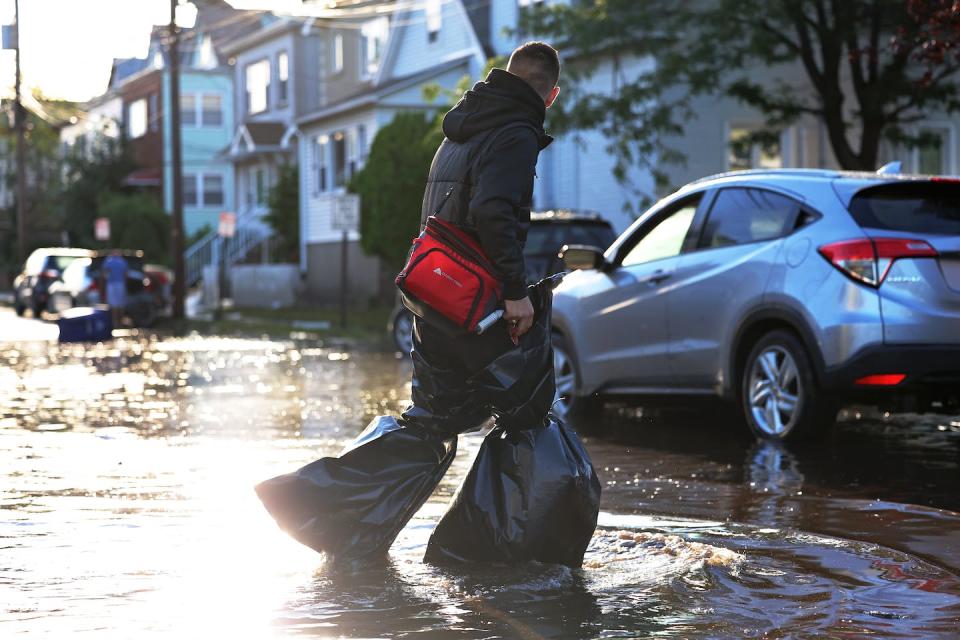 Many waterborne diseases can be spread by climate hazards like flooding and extreme downpours. <a href="https://www.gettyimages.com/detail/news-photo/man-uses-garbage-bags-to-keep-his-pants-and-feet-dry-as-he-news-photo/1337826833" rel="nofollow noopener" target="_blank" data-ylk="slk:Michael M. Santiago/Getty Images;elm:context_link;itc:0;sec:content-canvas" class="link ">Michael M. Santiago/Getty Images</a>