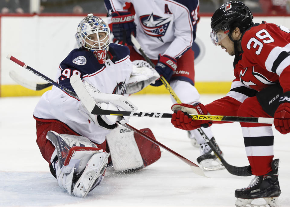 New Jersey Devils right wing Nicholas Merkley (39) watches as his shot goes past Columbus Blue Jackets goaltender Elvis Merzlikins (90) for a goal during the second period of an NHL hockey game Sunday, Feb. 16, 2020, in Newark, N.J. (AP Photo/Kathy Willens)