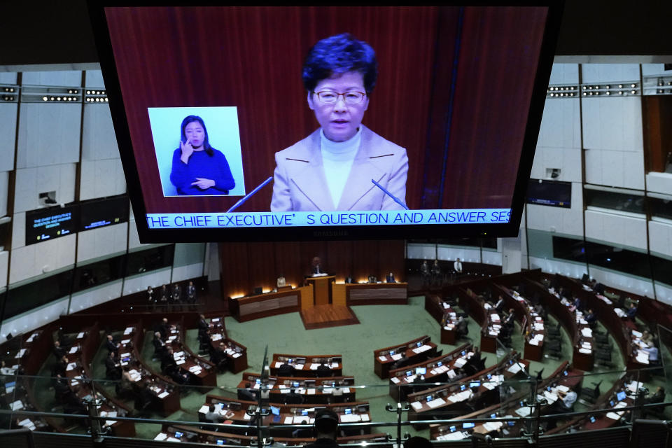 Hong Kong Chief Executive Carrie Lam appears at a TV screen while speaking during a question and answer session at the Legislative Council in Hong Kong Thursday, Jan. 16, 2020. (AP Photo/Vincent Yu)