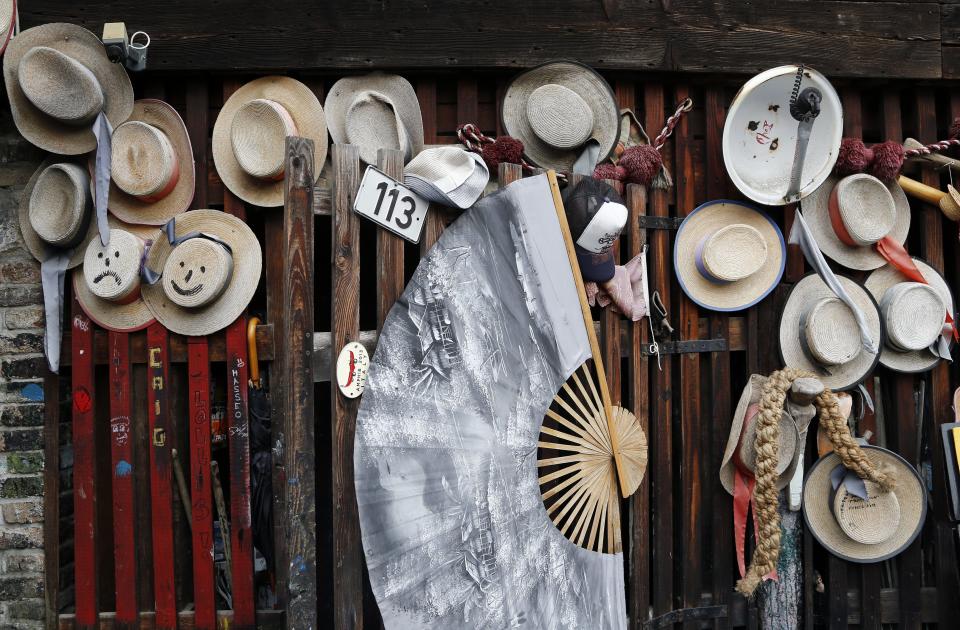 The hats of Venetian gondoliers hang on a wall outside San Trovaso boatyard, also known as a