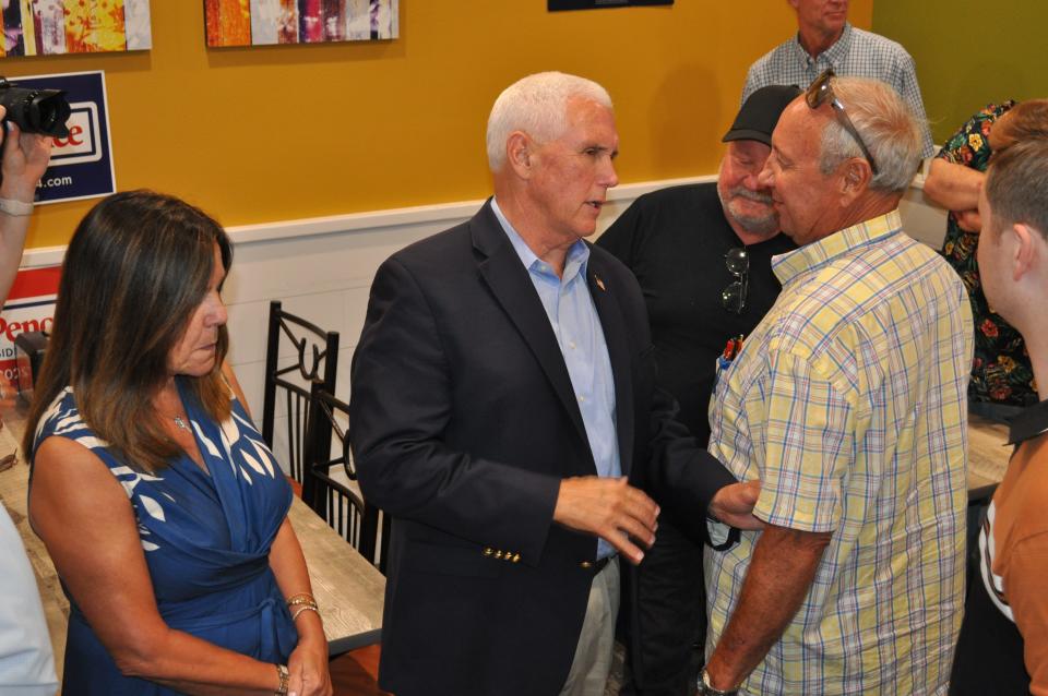 Mike Pence and his wife, Karen, talk to a voter at a town hall in Sioux City, Iowa. At a later event, Pence told the crowd, "In this moment in the life of our nation Karen Pence and I just feel called to step forward."