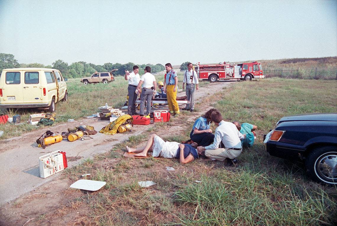 Aug. 31, 1988: Emergency medical personnel aid three of the survivors of the Delta 1141 crash about 200 yards from the wreckage. Sixty-eight people walked away from the disaster with minor or no injuries.