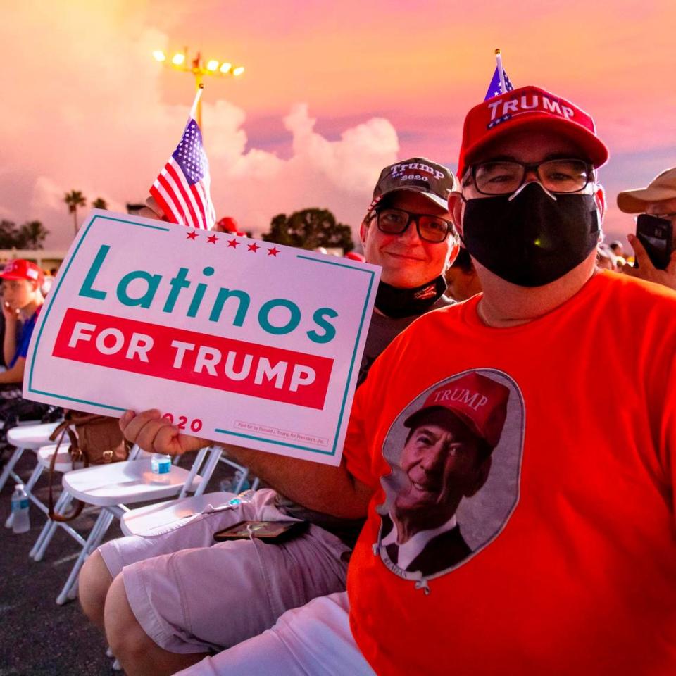 Trump supporters and Miami residents Juan Llanes, 57, and George Hubbard, 53, sit as they wait for Donald Trump Jr. to speak at the ‘Fighters against Socialism’ event at the Wings Over Miami Museum in Miami, Florida, on Sunday, October 11, 2020.