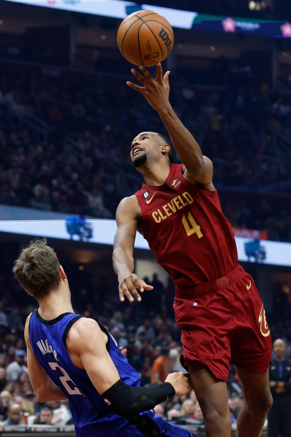 Cleveland Cavaliers forward Evan Mobley (4) shoots against Orlando Magic center Moritz Wagner (21) during the first half of an NBA basketball game Friday, Dec. 2, 2022, in Cleveland. (AP Photo/Ron Schwane)