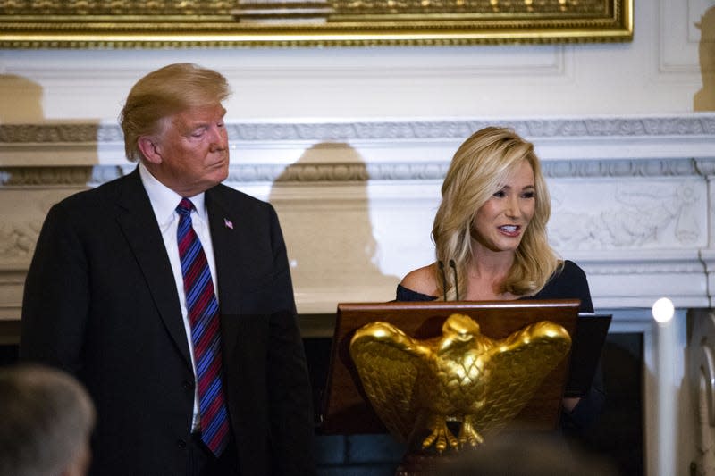 Pastor Paula White leads a prayer beside U.S. President Donald Trump during a dinner celebrating Evangelical leadership in the State Dining Room of the White House in Washington, D.C., U.S.,on Monday, Aug. 27, 2018. After the American Legion wrote a letter imploring recognition of late Senator John McCain, Trump relented during his dinner speech stating “We very much appreciate everything that Senator McCain has done for our country.” - Photo: Al Drago/Bloomberg (Getty Images)