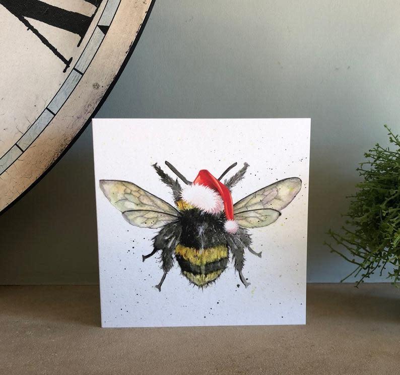 <h2>Sarah Boddy UK</h2><br>If you're following stay-at-home orders, Sarah makes sending holiday cheer seamless. She'll customize a hand-drawn card and send it right to the recipient for you. Win-win. <br><br><strong><em><a href="https://fave.co/2HGxxPT" rel="nofollow noopener" target="_blank" data-ylk="slk:SarahBoddyUK" class="link ">SarahBoddyUK</a></em></strong><br><br><strong>SarahBoddyUK</strong> Bumble Bee Christmas Card, $, available at <a href="https://go.skimresources.com/?id=30283X879131&url=https%3A%2F%2Fwww.etsy.com%2Flisting%2F554522108%2Fbumble-bee-christmas-card-bee-card" rel="nofollow noopener" target="_blank" data-ylk="slk:Etsy" class="link ">Etsy</a>