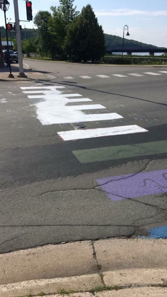 The crosswalk was defaced last weekend, when someone splashed white colour on the road and painted it over most of the colourful stripes.