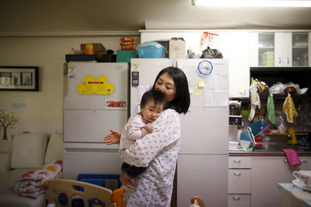 Jeong Bo-mi, 37, among a group of South Korean parents who sued a post-partum care centre seeking compensation after babies were infected with latent tuberculosis, takes care of her baby, who was not infected but was treated as a preventive measure, at her home in Seoul, South Korea, April 7, 2016. REUTERS/Kim Hong-Ji