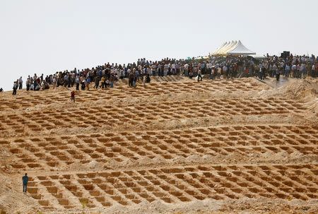 Grave holes are prepared as family members and friends attend the funeral of victims of a suicide bombing at a wedding celebration in the southern Turkish city of Gaziantep, Turkey, August 21, 2016. REUTERS/Osman Orsal