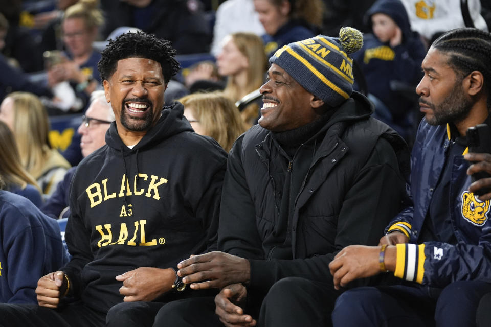 Former Fab Five Michigan basketball players Jalen Rose, from left, Chris Webber, and Jimmy King watch in the first half of an NCAA college basketball game against Ohio State in Ann Arbor, Mich., Monday, Jan. 15, 2024. (AP Photo/Paul Sancya)