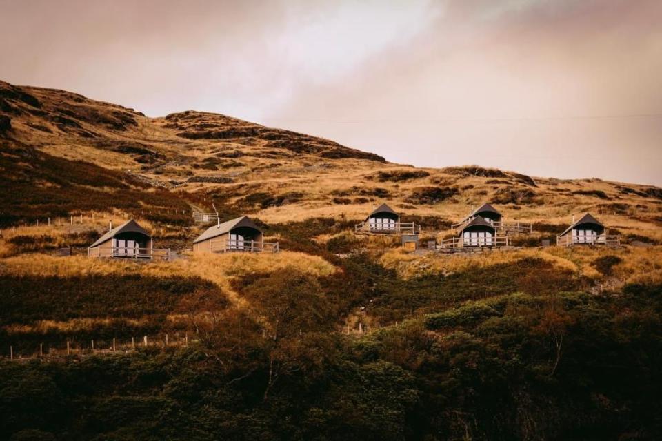 <p>For something a little different, why not stay in a verdant fold of the Snowdonia National Park in a luxury safari tent? Sleeping up to five people, each spacious tent at <a href="https://www.booking.com/hotel/gb/llechwedd-glamping.en-gb.html?aid=2070935&label=places-to-stay-snowdonia" rel="nofollow noopener" target="_blank" data-ylk="slk:Llechwedd Glamping" class="link ">Llechwedd Glamping</a> is fully insulated against the wild weather, making it a cosy glamping experience in Snowdonia. </p><p>All the tents are furnished with an en-suite bathroom, a kitchenette and a wood burning stove, plus a private deck overlooking the mountains. A full Welsh breakfast is served in the camp cafe, which also serves toasties and homemade cakes.</p><p><a class="link " href="https://www.booking.com/hotel/gb/llechwedd-glamping.en-gb.html?aid=2070935&label=places-to-stay-snowdonia" rel="nofollow noopener" target="_blank" data-ylk="slk:CHECK AVAILABILITY">CHECK AVAILABILITY</a></p>