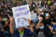 A protester holds a sign depicting Thai Prime Minister Prayuth Chan-Ocha during a protest demanding the resignation of the government in Bangkok