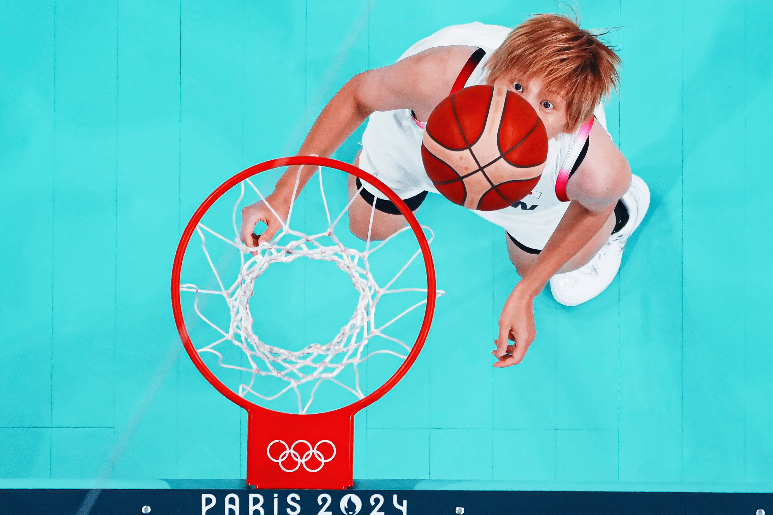 An overview shows Japan's #08 Maki Takada eyeing the ball in the women's preliminary round group C basketball match between Japan and Germany during the Paris 2024 Olympic Games at the Pierre-Mauroy stadium in Villeneuve-d'Ascq, northern France, on August 1, 2024.(Photo by -/POOL/AFP via Getty Images)
