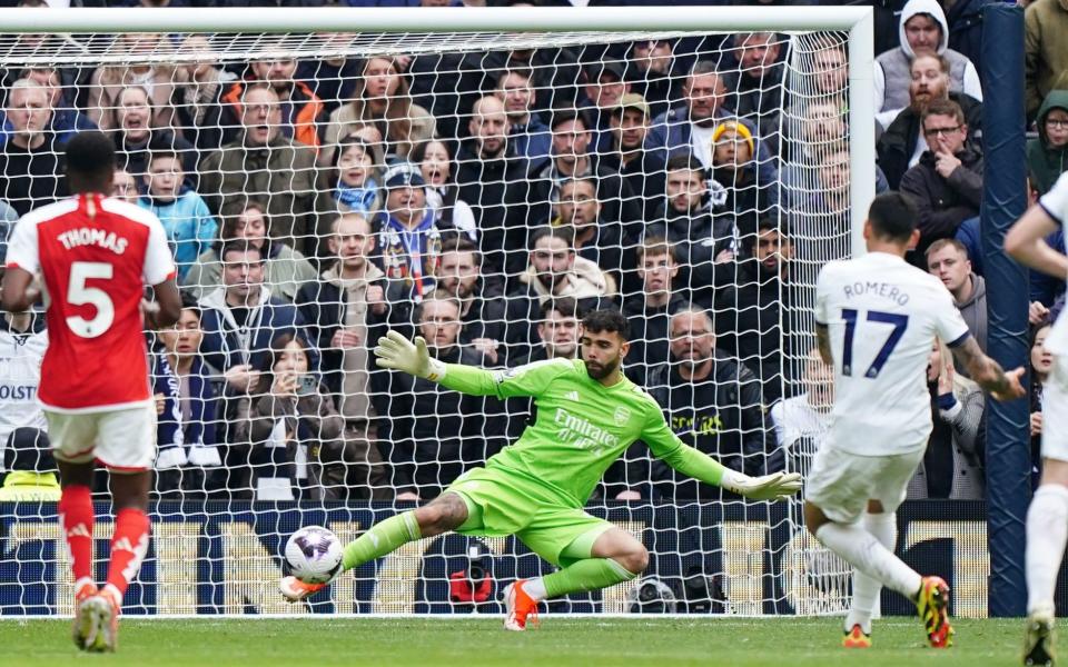 Tottenham Hotspur's Cristian Romero shoots past Arsenal goalkeeper David Raya to score