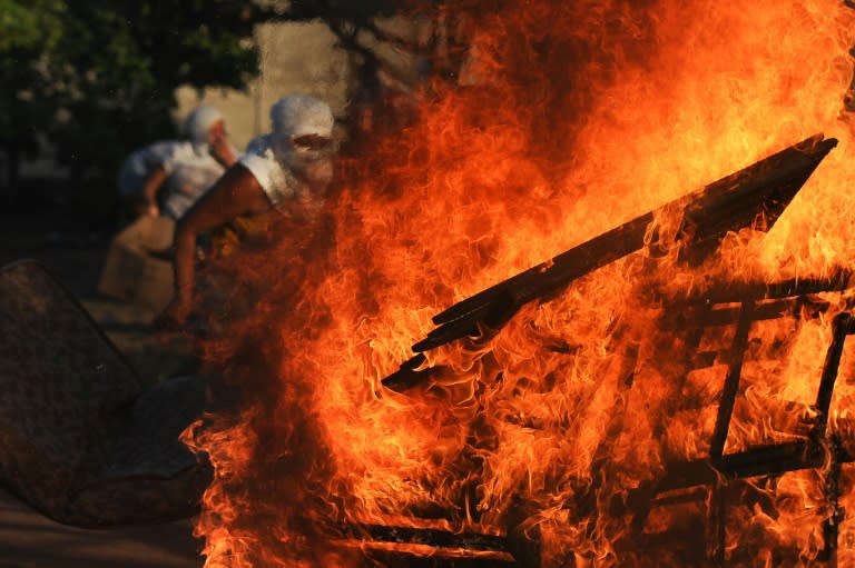 Women relatives of inmates set makeshift barricades on fire in protest for the transfer of some 200 prisoners from the Alcacuz Penitentiary Center to other prisons in Rio Grande do Norte, Brazil on January 18, 2017