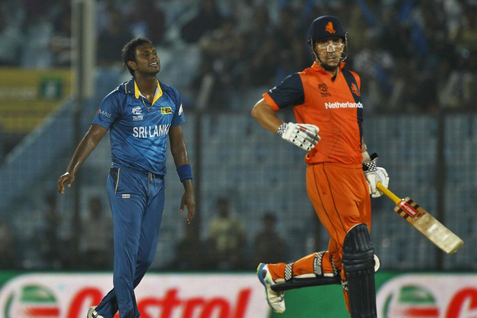 Sri Lanka's Ajantha Mendis, left, celebrates the wicket of Netherlands's Tom Cooper, right, during their ICC Twenty20 Cricket World Cup match in Chittagong, Bangladesh, Monday, March 24, 2014. (AP Photo/A.M. Ahad)