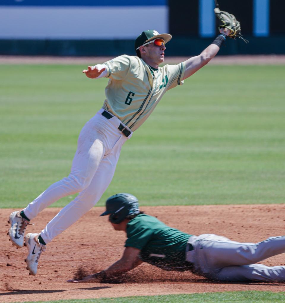 Jacksonville University second baseman Justin Nadeau leaps for a throw earlier this season against Stetson.
