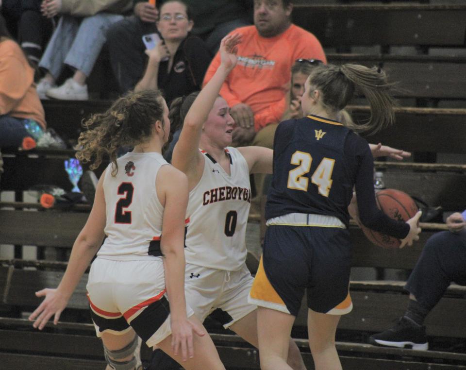 Cheboygan senior Emily Clark (2) and sophomore Jaelyn Wheelock (0) attempt to trap Gaylord's Karlee Pretzlaff (24) during the second half of Tuesday's girls basketball game in Cheboygan.