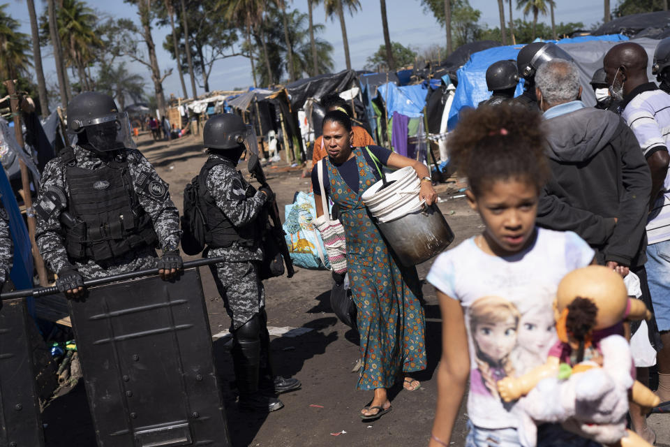 People are evicted from land designated for a Petrobras refinery, at a settlement coined the "First of May Refugee Camp," referring to the date people moved here and set up tents and shacks to live in during the new coronavirus pandemic in Itaguai, Rio de Janeiro state, Brazil, Thursday, July 1, 2021. (AP Photo/Silvia Izquierdo)