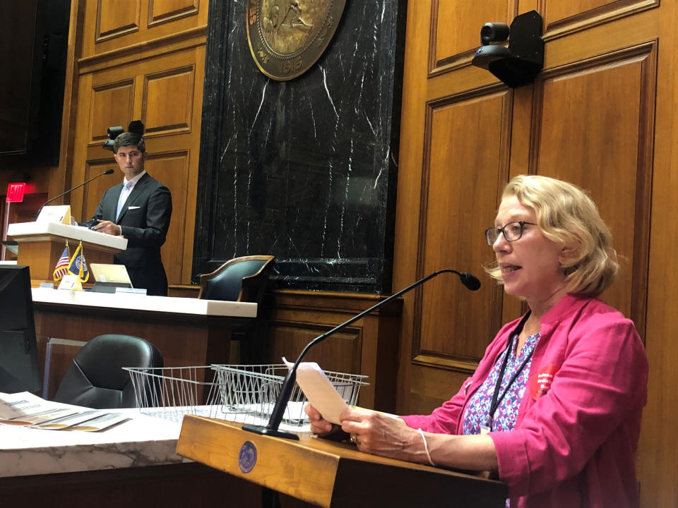 Julia Vaughn, executive director of Common Cause Indiana, speaks during a legislative redistricting hearing as Republican Rep. Tim Wesco, chairman of the Indiana House Elections Committee, looks on at the Indiana Statehouse in Indianapolis on Aug. 11, 2021. (AP Photo/Tom Davies)