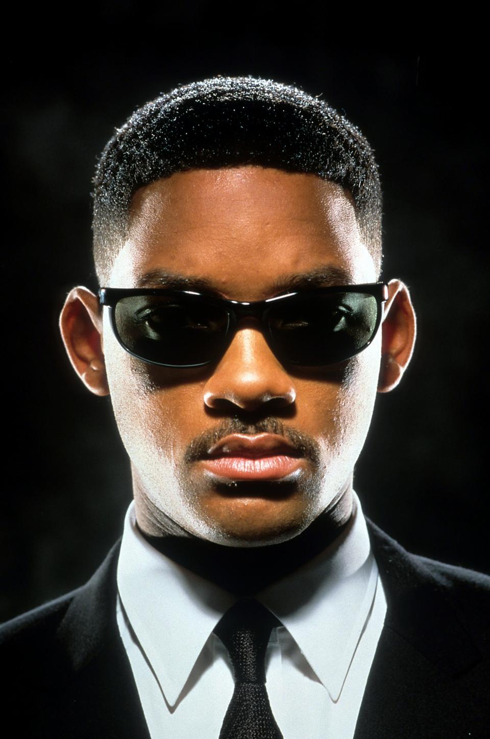 Will Smith in a black suit and black sun glasses