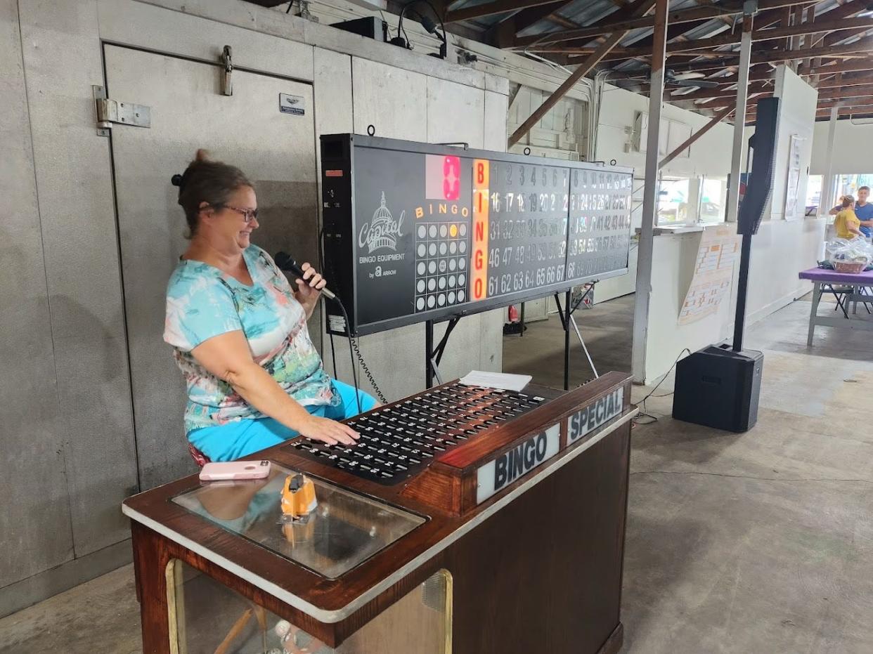 Crystal Dagastino calls numbers and letters during a bingo game at the Monroe County Fair.