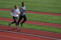 <p>Ashton Eaton (R) of the USA Track and Field Team and his fiancee Brianne Theisen, Canadian Heptathlete, train at Hayward Field on the campus of the University of Oregon on April 11, 2013 in Eugene, Oregon. Eaton is the reigning Olympic gold medalist and world record holder in the decathlon. (Photo by Doug Pensinger/Getty Images) </p>