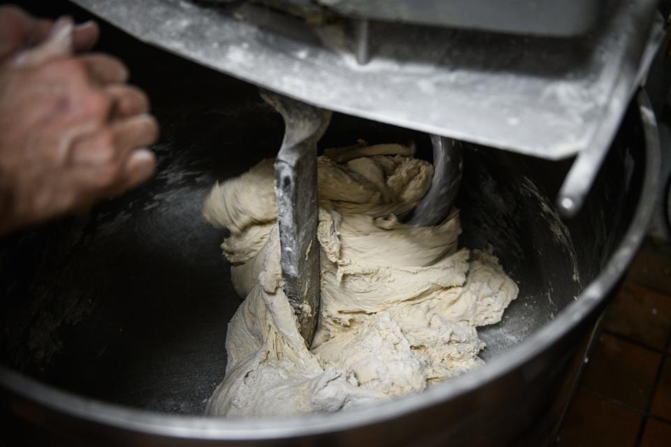 Dough goes round and round in a mixing bowl at Superior Bakery on Wednesday, April 19, 2023.