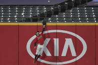 Cleveland Indians' Tyler Naquin leaps for but can't reach a two-run home run hit by New York Yankees' Gary Sanchez during the sixth inning of Game 2 of an American League wild-card baseball series, Wednesday, Sept. 30, 2020, in Cleveland. (AP Photo/David Dermer)