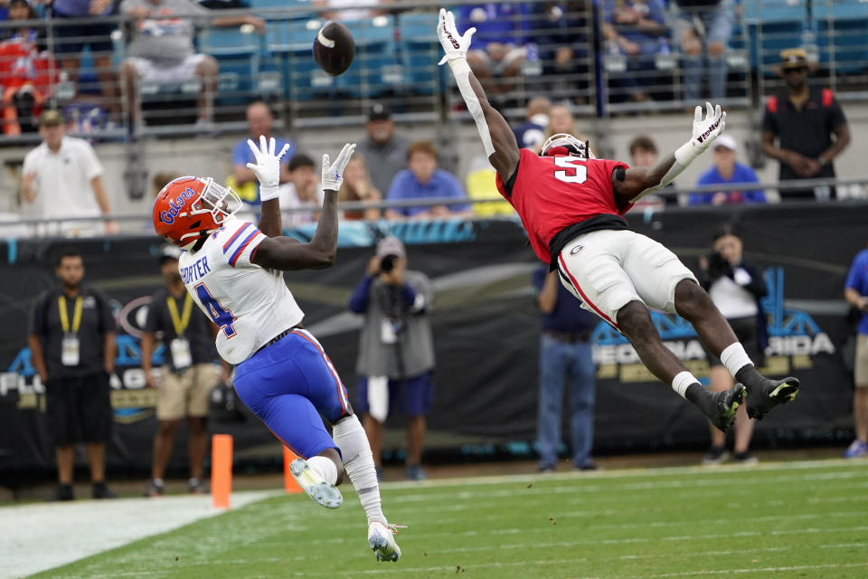 Florida wide receiver Justin Shorter (4) makes a reception in front of Georgia defensive back Kelee Ringo (5) during the first half of an NCAA college football game Saturday, Oct. 29, 2022, in Jacksonville, Fla. (AP Photo/John Raoux)