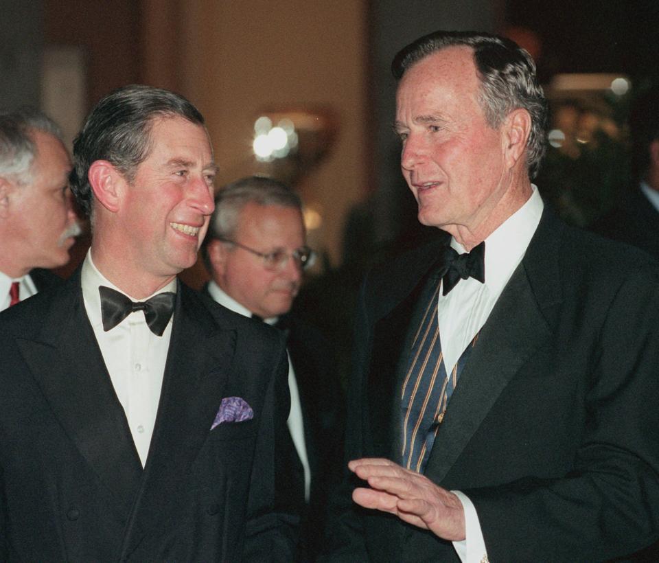 FILE - Britain's Prince Charles, left, and former President George H.W. Bush talk as they arrive for the Gala Inaugural for Founding Sponsors of the American Associates of the Saint Catherine Foundation, March 11, 1997, at the Metropolitan Museum of Art in New York. (AP Photo/Adam Nadel, File)