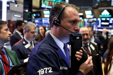 Traders work on the floor of the New York Stock Exchange shortly after the opening bell in New York, U.S., January 19, 2018. REUTERS/Lucas Jackson