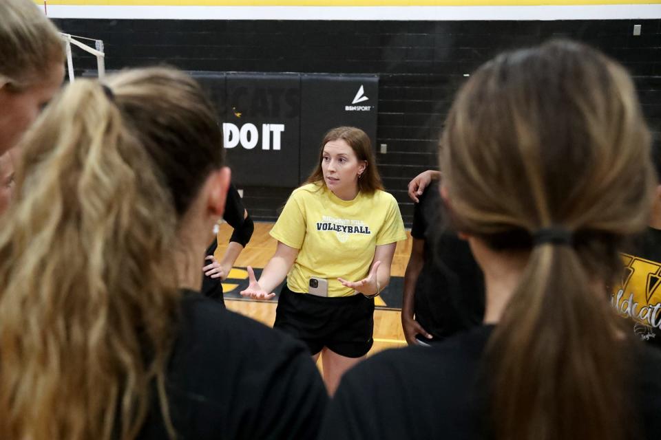 Richmond Hill volleyball coach Kaitlyn Bean talks with the team during practice on Monday, August 28, 2023.