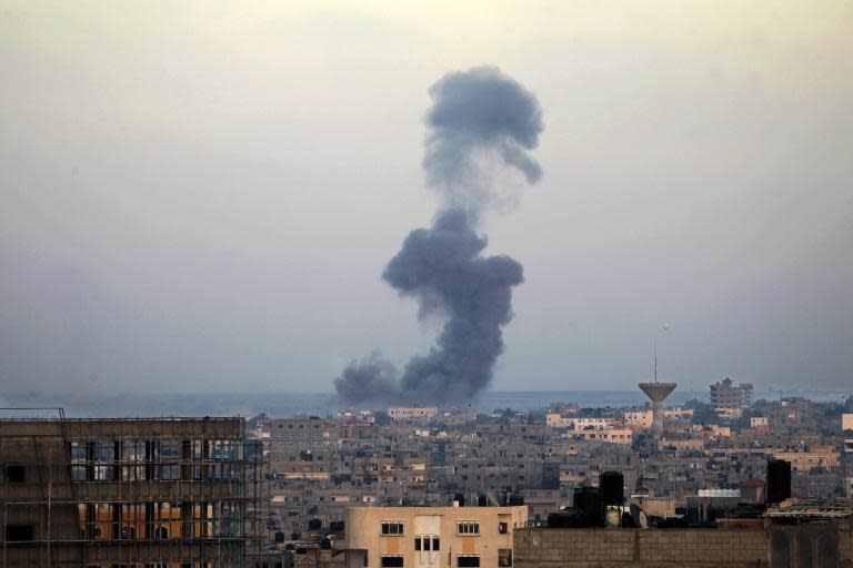 Smoke billows from buildings following an Israeli air strike in Rafah, in the southern Gaza Strip, on July 31, 2014